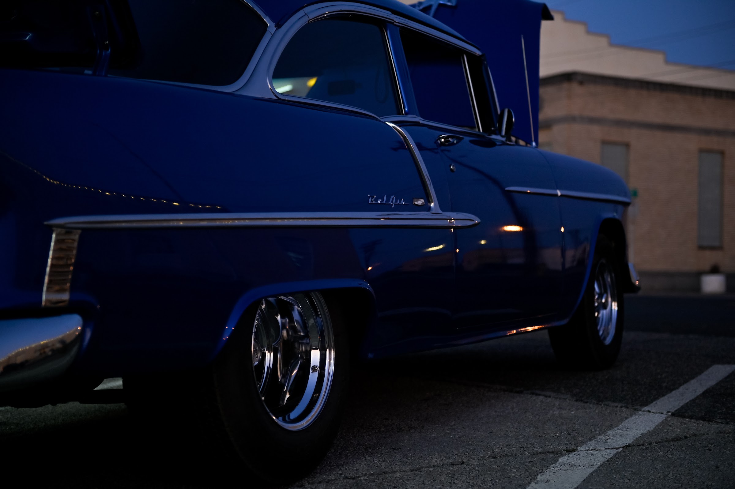 A vintage deep blue car with chrome trim resting in a parking spot at dusk — car photography in East Texas by Kaden Baker