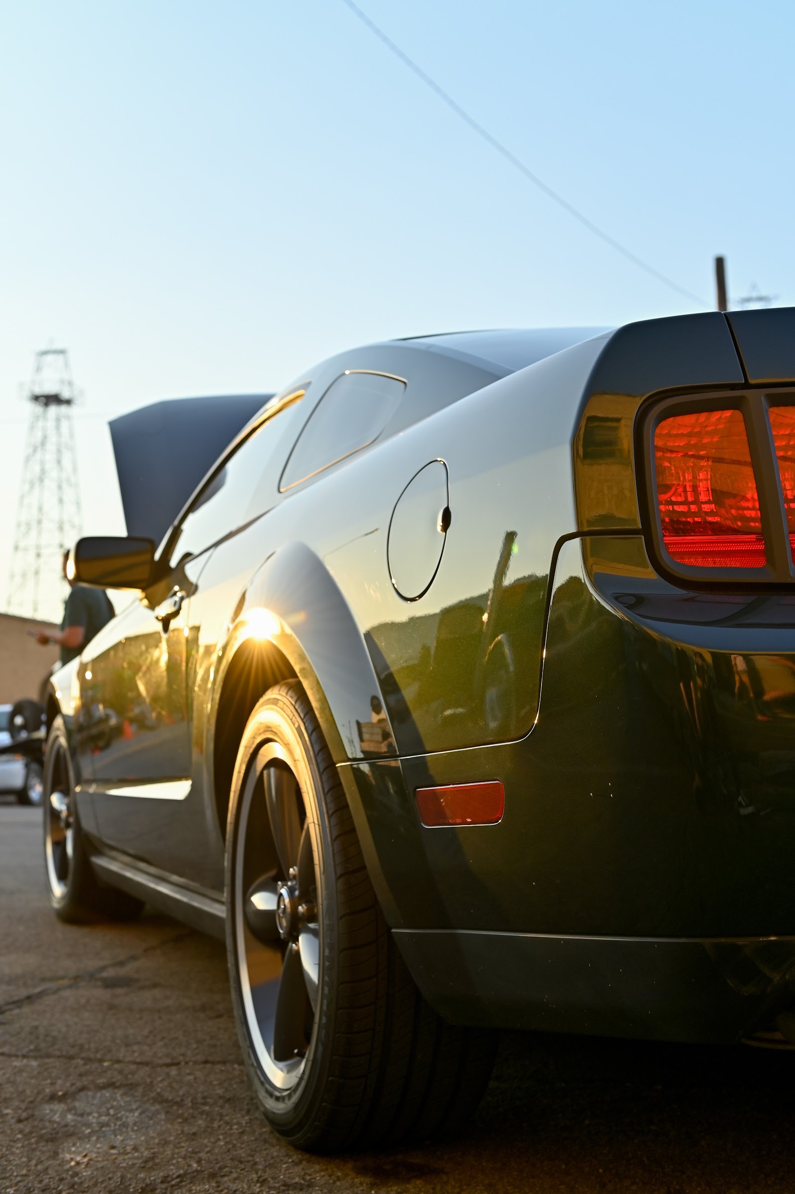 A dark green muscle car at dusk with evening sun on its rear fender — car photography in East Texas by Kaden Baker